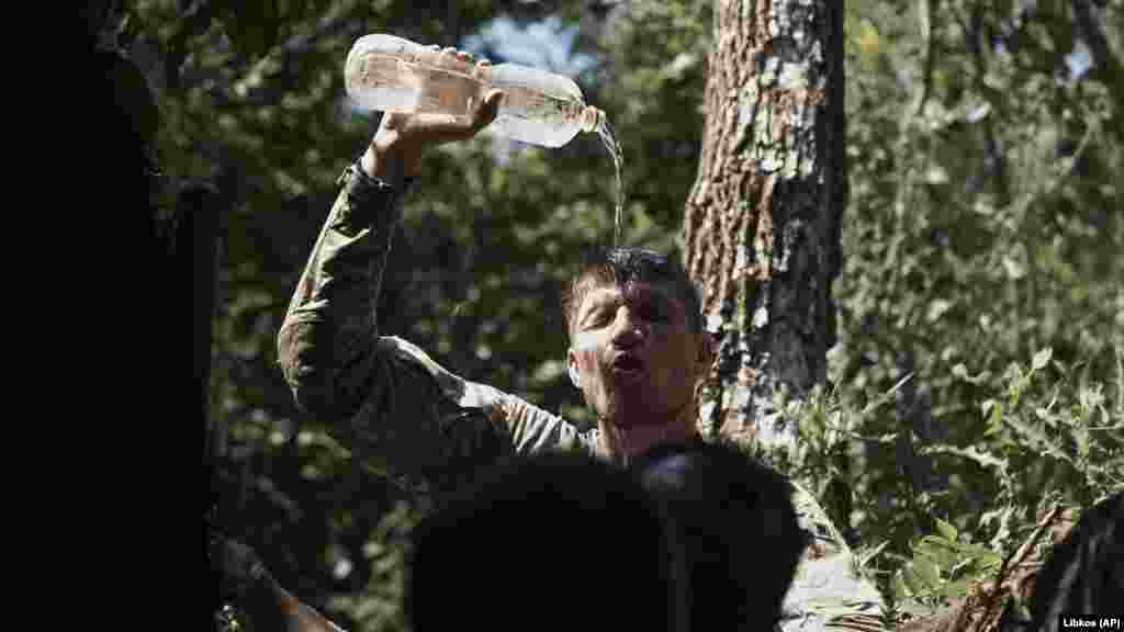 A Ukrainian soldier cools himself off. Hundred of cities and towns form part of a front line that stretches from the northern Donbas to the south of Ukraine in Kherson -- nearly 1,000 kilometers of trenches, minefields, rivers, and other obstacles that separate Ukrainian troops from their Russian counterparts.