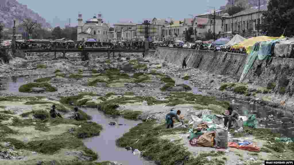Ragpickers besides a stream along the Kabul River in Kabul. Since the Taliban takeover of Afghanistan in August 2021, the country has been gripped by an economic meltdown. Around half of Afghanistan's 40 million people are "acutely food insecure," according to the UN, with 6 million on the brink of starvation. 