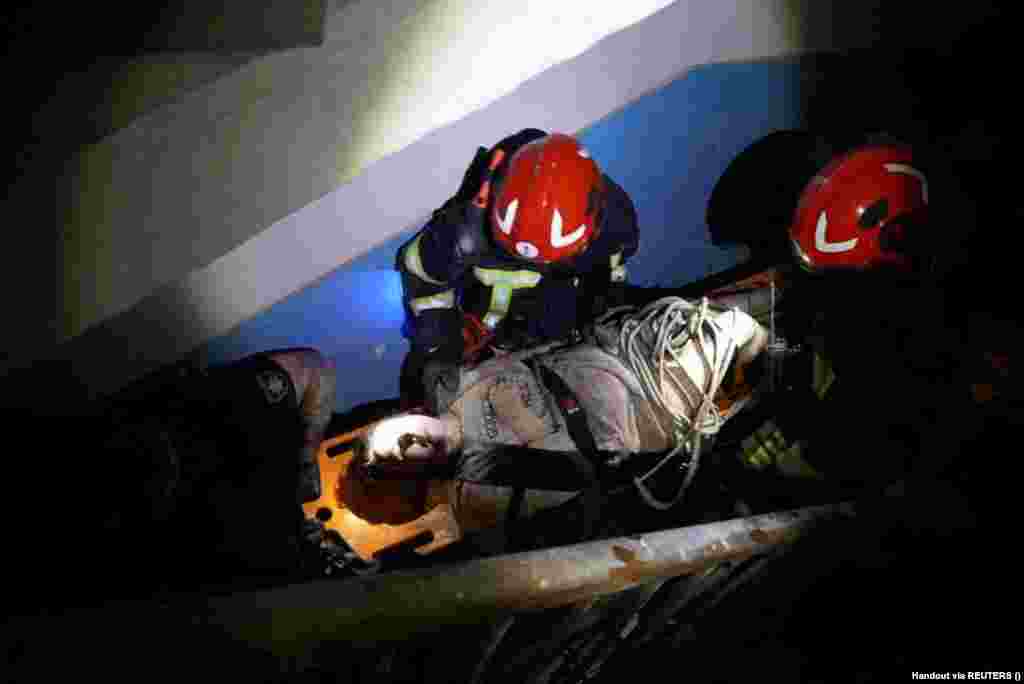 An injured person is removed from a residential building. 