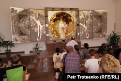Parishioners pray in front of the "Star of Kazakhstan" altar, designed by Polish artist Mariusz Drapikowski.