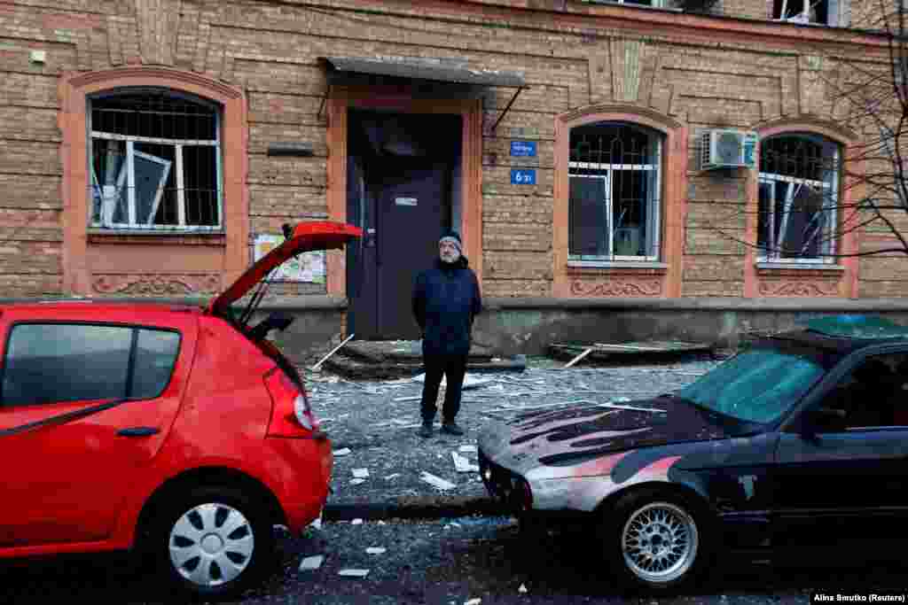 A man stands near damaged vehicles. "After a pause of 44 days, the enemy launched another missile attack on Kyiv," he said. "All emergency services are working at the sites. Clearing the consequences of the missile attack is under way," Popko said.