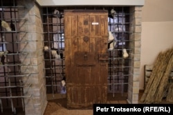An installation depicting victims locked behind the door of the pretrial detention center.