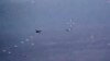 In this image from video released by the U.S. Air Force, Russian military jets release flares in the flight path of a U.S. Air Force MQ-9 Reaper drone on July 6. The United States said on July 8 that its drones had been harassed for the third day in a row. 