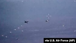 In this image from video released by the U.S. Air Force, Russian military jets release flares in the flight path of a U.S. Air Force MQ-9 Reaper drone on July 6. The United States said on July 8 that its drones had been harassed for the third day in a row. 