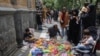 People buy slippers from a street vendor at the Grand Bazaar in Tehran. (file photo)