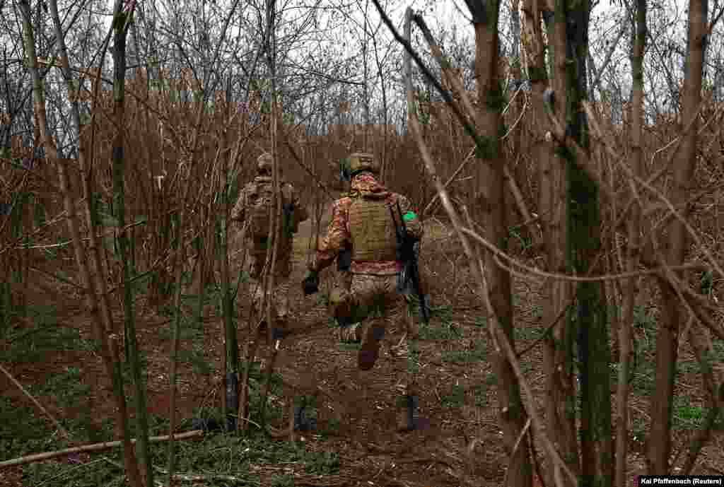 Ukrainian soldiers from the 28th Mechanized Brigade run between positions at the front line. Despite Ukrainian forces being outnumbered, President Volodymyr Zelenskiy said his troops would keep fighting for Bakhmut despite the "very, very difficult" situation there.
