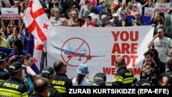 People protest the resumption of air links with Russia during the arrival of the first direct flight from Moscow to Tbilisi on May 19.