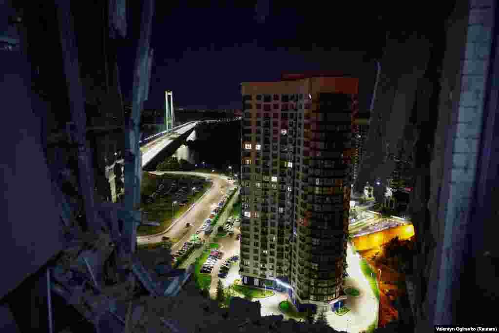 A residential building is seen from a damaged apartment. The head of Kyiv's military administration, Serhiy Popko, described the assault as a "mass attack" by Iranian-made Shahed drones that had approached from different directions.