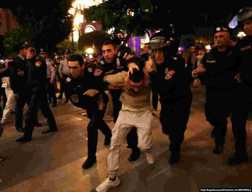 Law enforcement officers detain a protester near a government building in Yerevan on September 21. Baku says it has plans to reintegrate Nagorno-Karabakh and its ethnic Armenian population back into Azerbaijan. But the Azerbaijani authorities aren't saying what the plan is, and the details remain far from clear. The first session of "reintegration" talks ended on September 21 without any sign of a breakthrough.