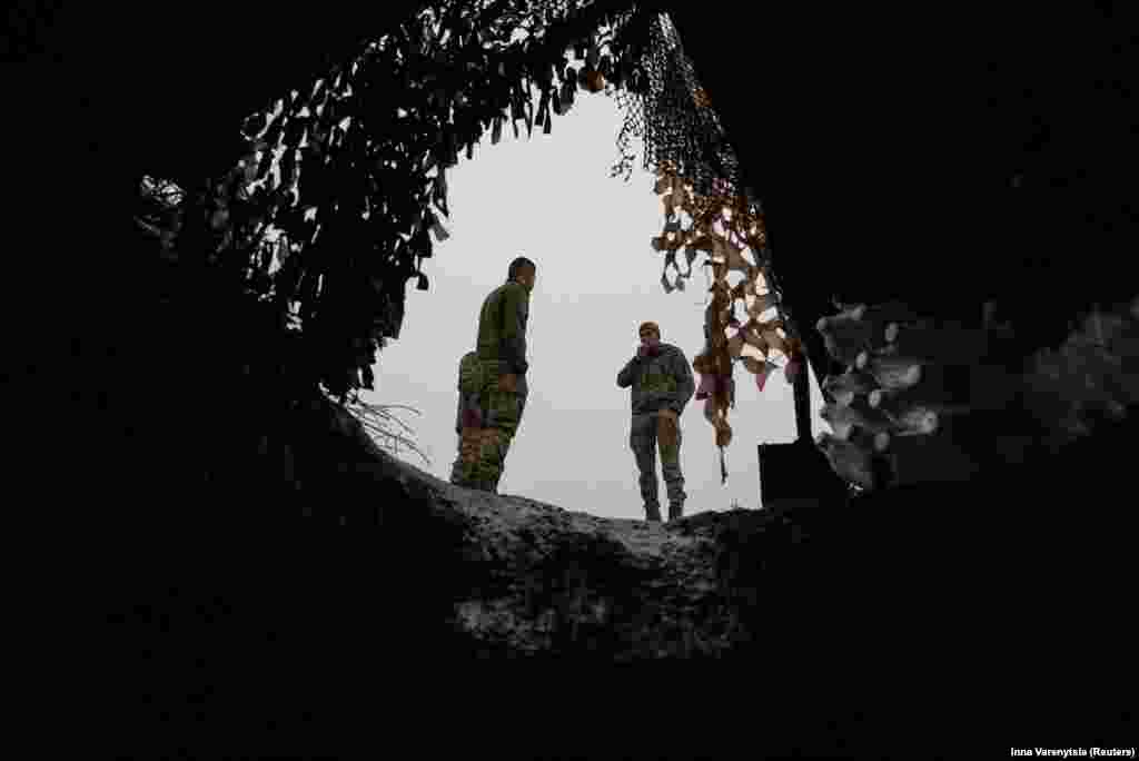 Ukrainian soldiers enjoy a cigarette break near the entrance to their dugout during a lull in fighting near Bakhmut on December 15. Prior to Tarnavskiy&#39;s remarks, Kyiv had said its forces had no intention of letting up the fight and would soldier on. &nbsp;