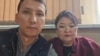 Civil activist Abzal Dostiyarov and lawyer Zhanar Balgabaeva at a police station in Almaty on September 22.