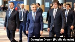 Georgian Dream Chairman Irakli Garibashvili (left), influential billionaire founder Bidzina Ivanishvili (center), and Prime Minister Irakli Kobakhidze (right) attend the party's congress in Tbilisi in February.