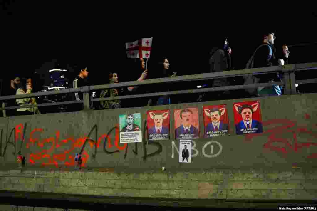 Portraits of the leaders of the ruling Georgian Dream party are covered in graffiti with the inscription "No To Russian Regime." Georgians have been demonstrating in large numbers since a slightly modified version of the legislation was reintroduced on April 9.