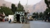 Taliban security personnel stand guard near the closed gates of the Torkham border crossing between Afghanistan and Pakistan in Afghanistan's eastern Nangarhar Province on September 6.