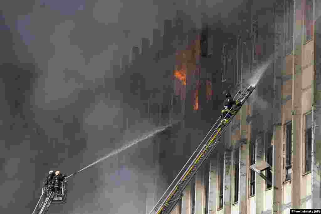Firemen work to extinguish the fire in the industrial building. 