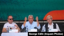 Viktor Orban (center) touched on many familiar issues during his nearly two-hour speech in a central Romanian spa town on July 27. 