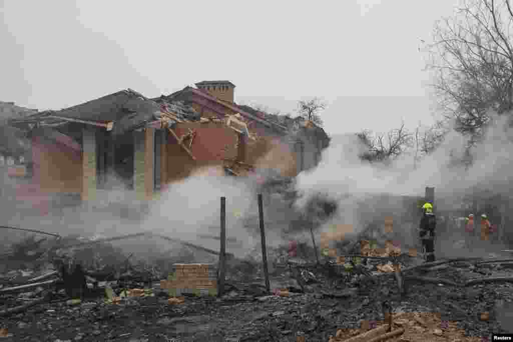 A rescuer stands in a residential area hit by a Russian missile. At least 10 houses in Odesa and some emergency service equipment were damaged in the attack, which started a blaze, according to Ukraine&rsquo;s Emergency Service and Regional Governor Oleh Kiper. &nbsp;