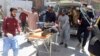Volunteers carry a blast victim on a stretcher at a hospital in Quetta on September 29.