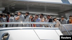 Migrants arrive at the Greek port of Kalamata following a rescue operation after their boat capsized in the Mediterranean Sea. Hundreds of people who were on the boat are still missing.