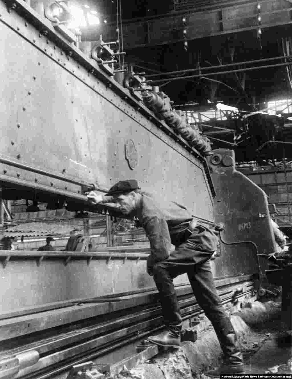 A mechanic checks on the assembly of heavy equipment during restoration work at the Stalin Machine Building Plant in Kramatorsk in the late 1940s. According to a declassified CIA report from 1952, the factory was "80 percent damaged during the war" and resumed full operation in May 1949.