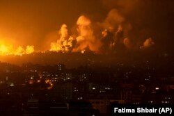 Fire and smoke rise following an Israeli air strike on Gaza City on October 8.