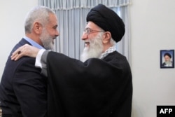 Ayatollah Ali Khamenei greets Hamas leader Ismail Haniyeh (left) during a meeting in Tehran in 2012.