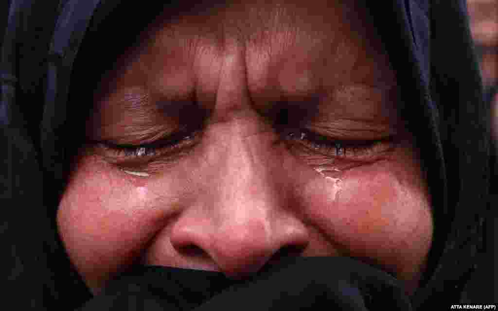 A woman mourns the death of Raisi in Tehran's Vali-Asr Square.
