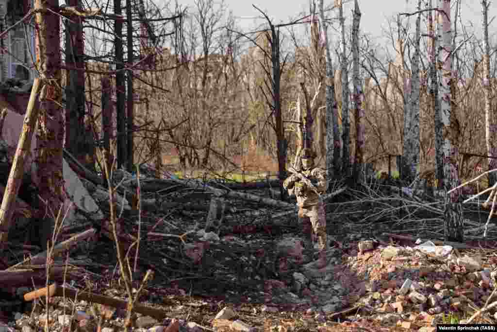 A mercenary with Russia’s Wagner group in the ruins of a property in Bakhmut on April 10. Most Russian fighters in Bakhmut are from the Wagner mercenary group, many of whom are are hardened criminals recruited from Russia's prisons. 