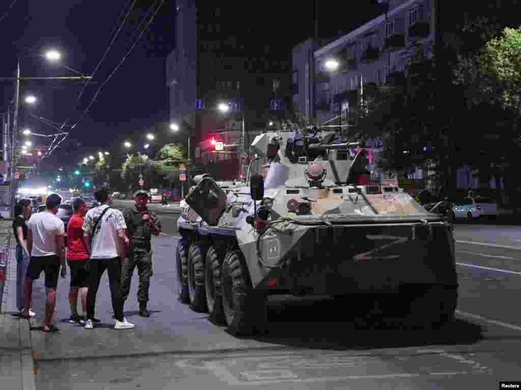 An image made before dawn on June 24 showing civilians in Rostov-on-Don gathered around an armored vehicle marked with the letter Z associated with Russia's invasion of Ukraine. 