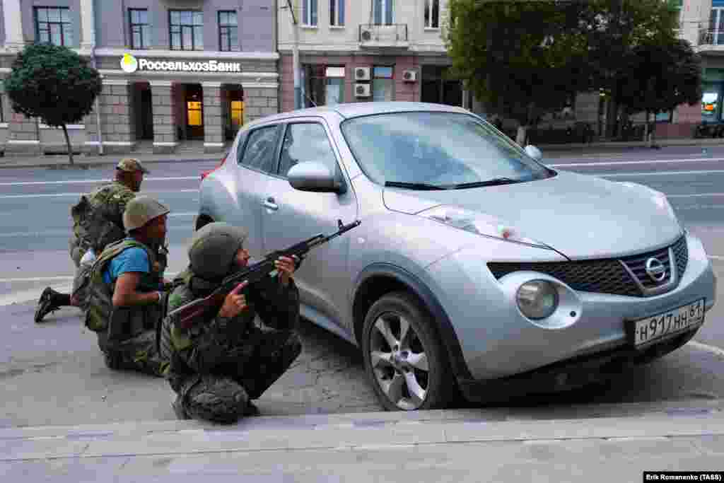 Men reportedly with the Wagner group take up positions behind a civilian car. Russia’s Federal Security Service announced a criminal case against Prigozhin for “incitement to armed rebellion” after he vowed to lead a “march of justice” against top officials in Russia’s Defense Ministry.