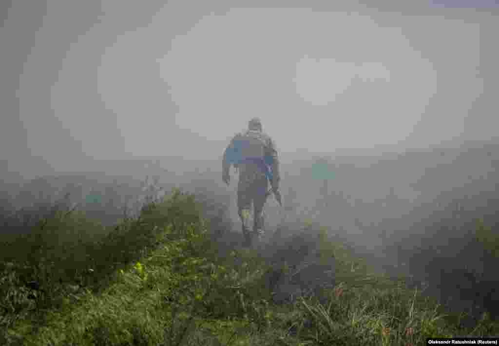 A Ukrainian soldier advances away from the liberated village as artillery fire rings out in the distance. Russia has not acknowledged any Ukrainian gains, and President Vladimir Putin said on June 13 that for now he saw no need for a new mobilization of fighting men to confront the Ukrainian counteroffensive launched last week.