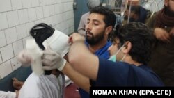 People who were injured in a blast receive medical treatment at a hospital in Bannu, Pakistan, on November 26.