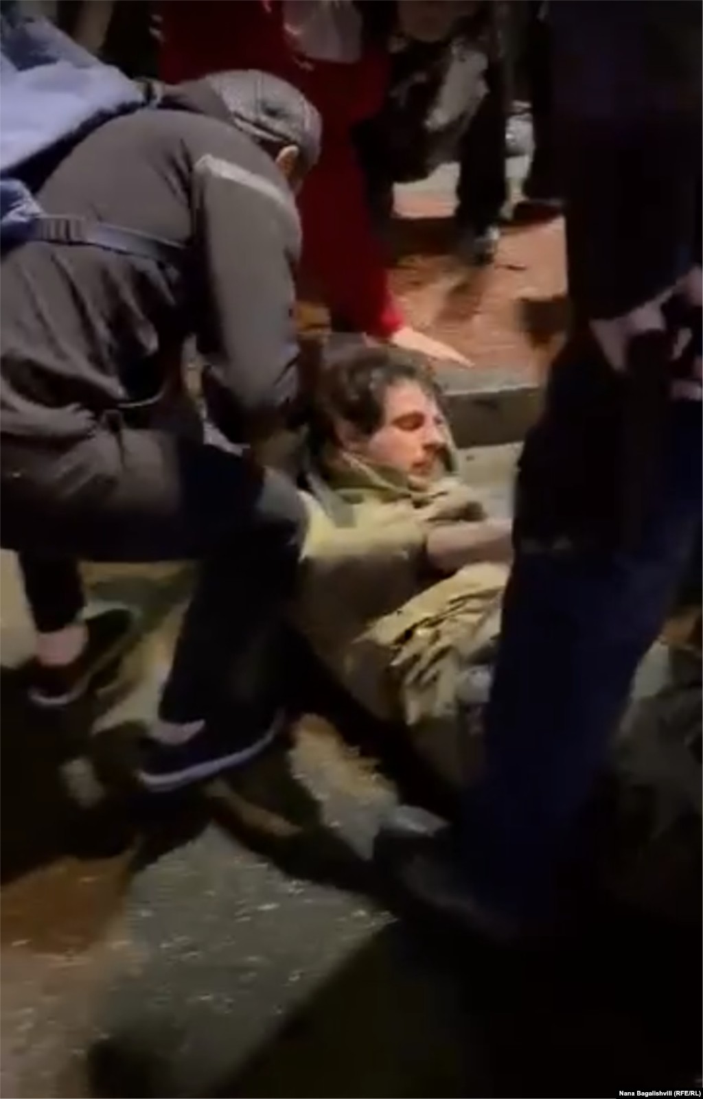 An injured man is helped by protesters at Heroes' Square early on May 3. Eyewitnesses, including two injured men, told RFE/RL that what they called "provocateurs" arrived by car around 1 a.m. and physically assaulted some of the protesters. 