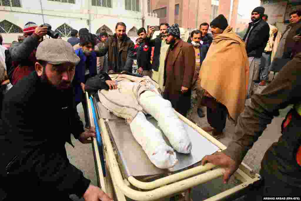 An injured man is transported to a hospital in Bajaur. Regional police spokesman Muhammad Asrar told RFE/RL's Radio Mashaal that the team of police personnel were on their way to guard polio workers performing immunizations in the area when their vehicle was hit by a roadside bomb.