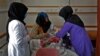 A trainee midwife examines a woman at a hospital in Bamiyan, Afghanistan, in March in a program spearheaded by the UN refugee agency with a local NGO.