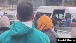 People gather in Tehran during the arrest of a woman in the street on January 13.