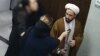 The video in question shows a woman without the mandatory hijab holding her baby, leading to widespread public and online outrage. 