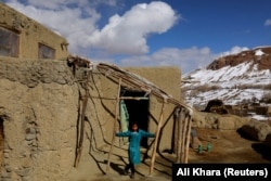 A young girl plays outside her home in the remote Foladi Valley.