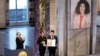 Narges Mohammadi's children hold the Nobel Peace Prize award, accepting it on behalf of their mother at Oslo City Hall on December 10.