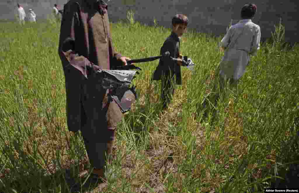 Local boys collect pieces from a U.S. helicopter one day after it was destroyed by the American commandos after crashing at bin Laden's compound. In 2020, Pakistani Prime Minister Imran Khan acknowledged probable “linkages” between his country’s military and bin Laden when the Al-Qaeda leader was hiding in Pakistan, but denied any high-level ties existed.