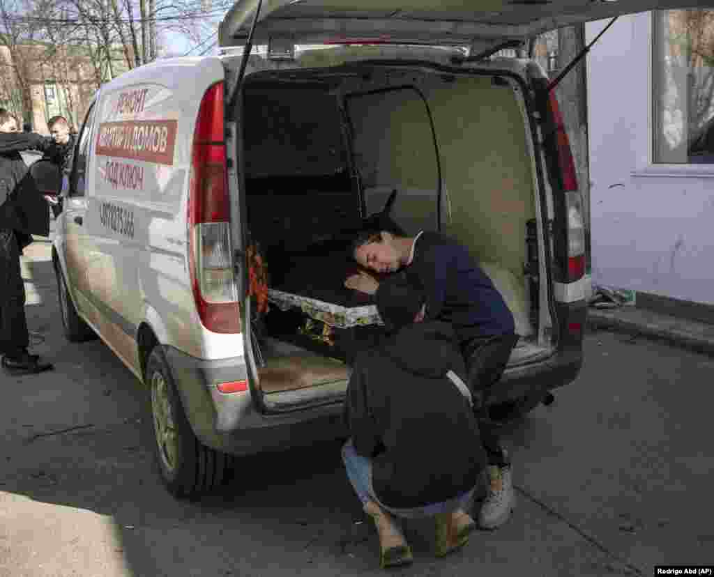 Oksana Kolesnikova embraces the coffin of her son, Anatoliy Kolesnikov, in Irpin, a town near Kyiv, on April 15. Thirty-year-old Anatoliy was a territorial defense soldier killed during the opening phase of the invasion of Ukraine. 