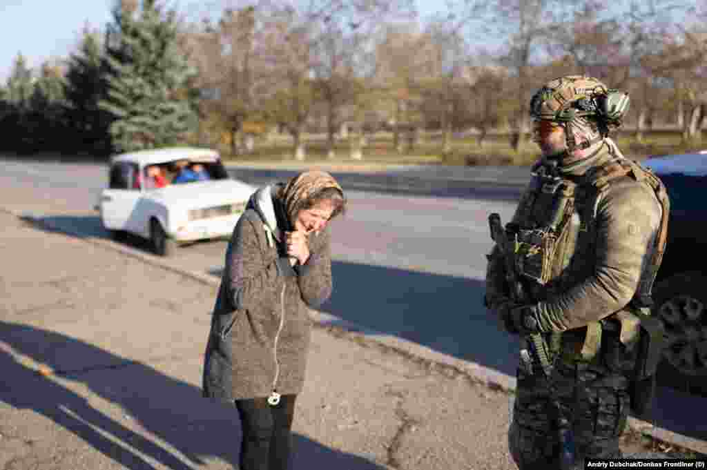 A woman weeps, moments before stepping forward and blessing a Ukrainian soldier. This and other photos in this gallery show the scenes in Snihurivka on the evening of November 10 as advance forces of the Ukrainian military recaptured the town in the southern Mykolayiv region.