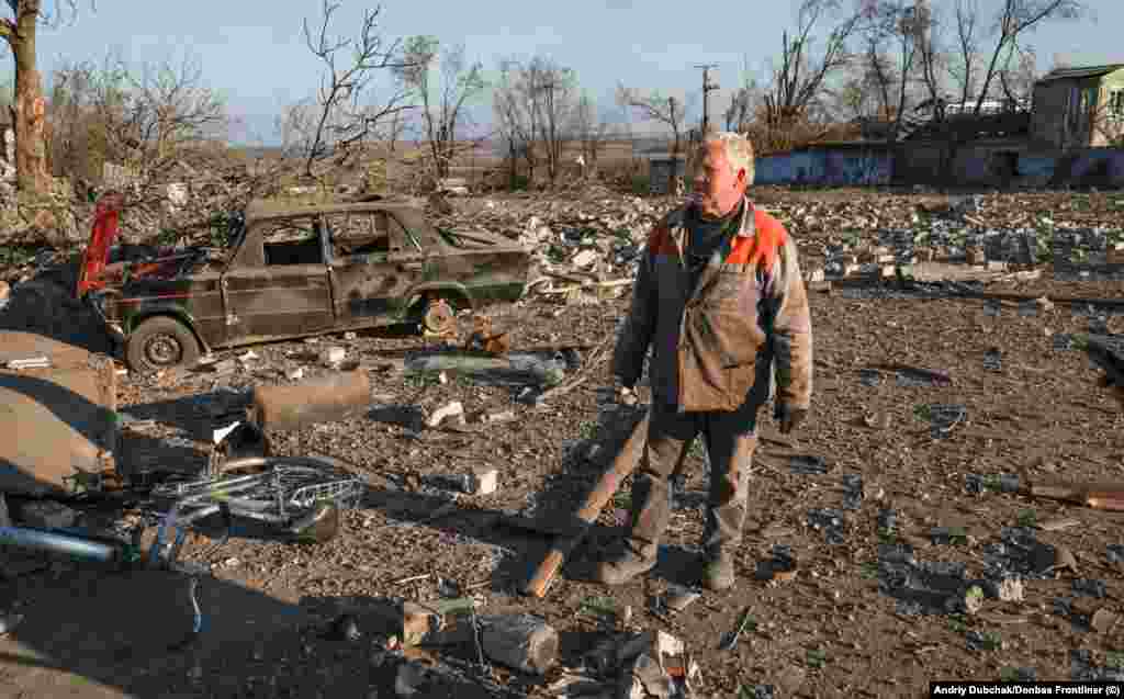 A local man looks over the aftermath of a battle in Snihurivka. 
