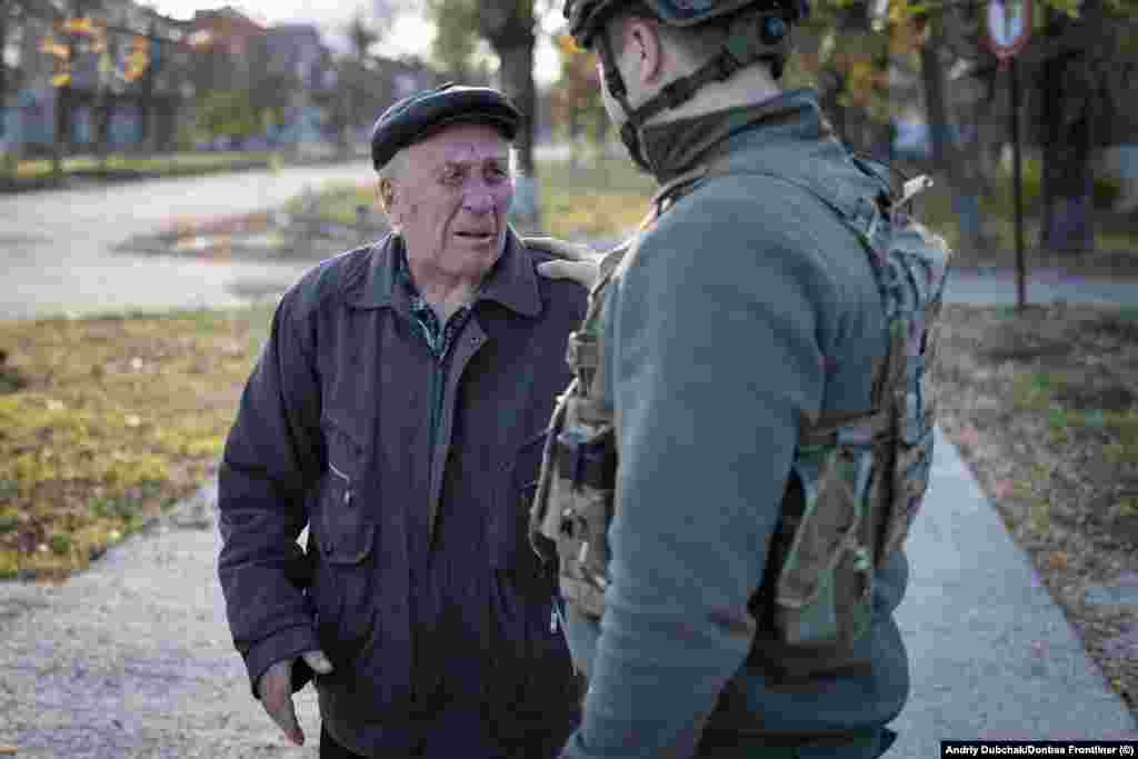 A man cries as he tells Ukrainian soldiers, "Don't leave us again, I'm begging you." These photos were taken by veteran Ukrainian conflict photojournalist Andriy Dubchak as he accompanied Ukrainian forces advancing south toward Kherson. 