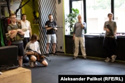 A class of tactical training for civilians organized by EBSH club convenes in Kyiv, with club co-owner Oleksandr Poloviy (second from left, in tank top and cap).
