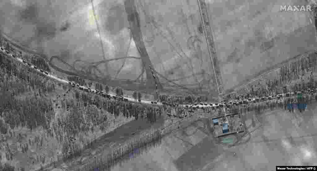 A closer view of the southern end of the main vehicle convoy of armor towed artillery trucks on the T-1011 highway east of Antonov Airport in Kyiv on February 28.
