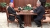 Russian President Vladimir Putin (left) attends a meeting with Defense Minister Sergei Shoigu in Moscow weeks after he ordered his country's troops to invade Ukraine, a move that Iver Neumann says could precipitate the end of the current Kremlin regime. 