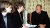 Russian President Vladimir Putin (right) talks with Irina Lyachin, the wife of the commander of the Kursk submarine, and her daughter in their flat in the naval town of Vidyayevo on August 22, 2000. 