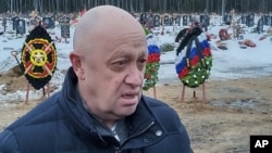 Vagner founder Yevgeny Prigozhin is seen at the funeral of one of his mercenaries -- prisoner Dmitry Menshikov, who died fighting in Ukraine -- at a cemetery outside St. Petersburg on December 24.