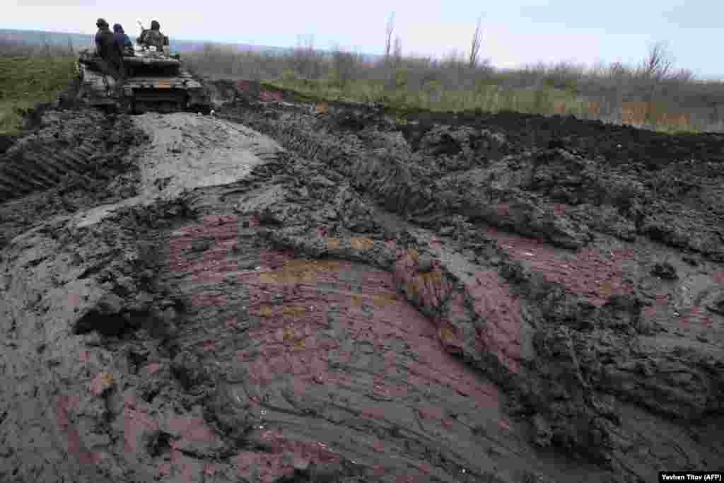 A Ukrainian tank churns through mud at an undisclosed location in November. 
